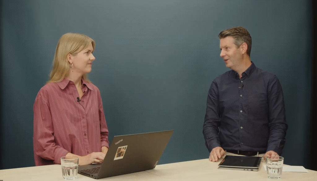 a man and a woman stand at a table and look at each other